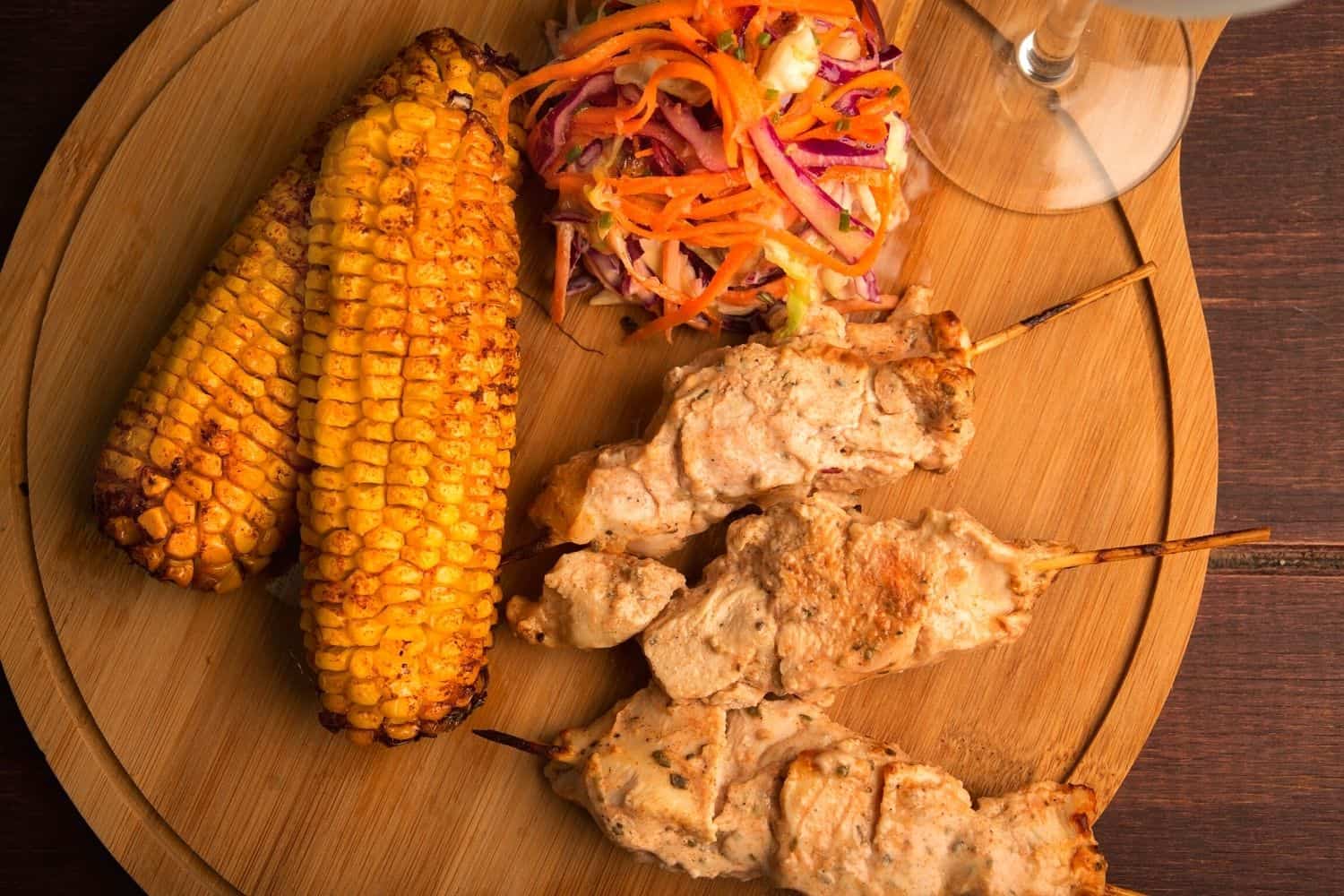 Chicken kebabs with grilled corn and crunchy slaw